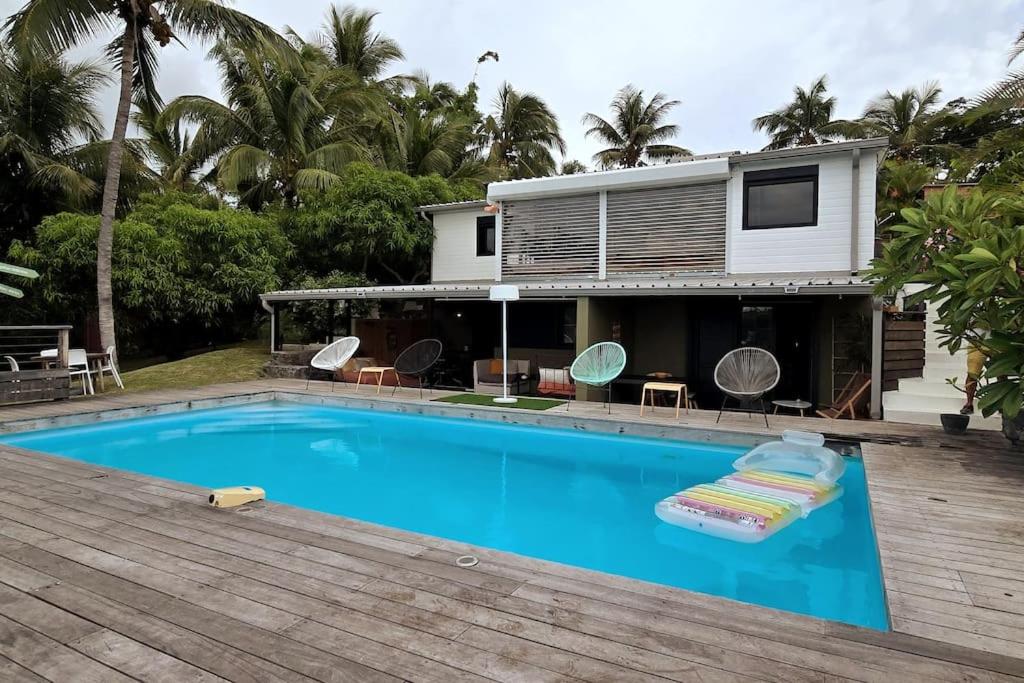 a house with a swimming pool in front of a house at La Baie des Mangues 1 - Baba Figue - Nibou in Saint-Paul