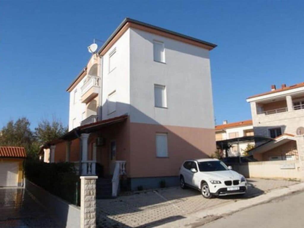 a white car parked in front of a building at Medulin Burle A4 1 in Medulin