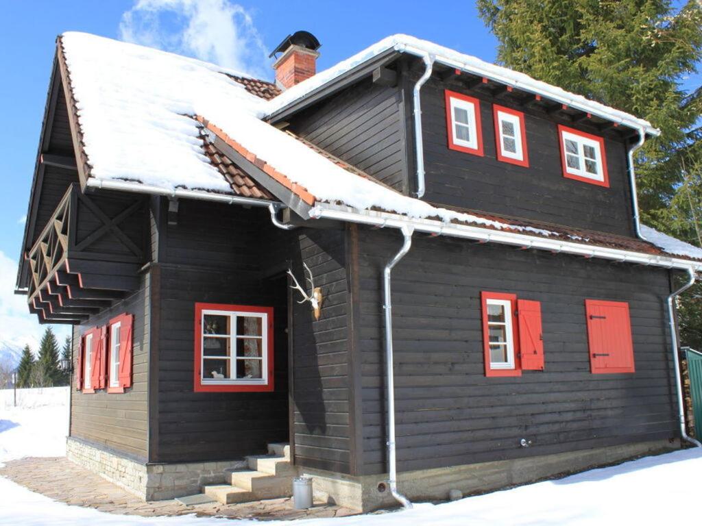a log cabin with snow on the roof at Heidi's house Comfortable Vacation Home in Bad Mitterndorf