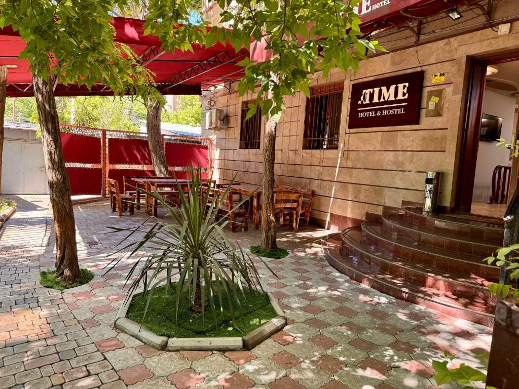 a patio of a restaurant with a table and chairs at Time Hotel & Tours in Yerevan