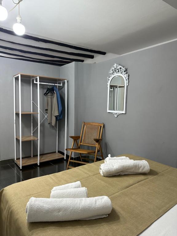 a room with a bed with two white towels on it at Civico168 in Castellammare del Golfo