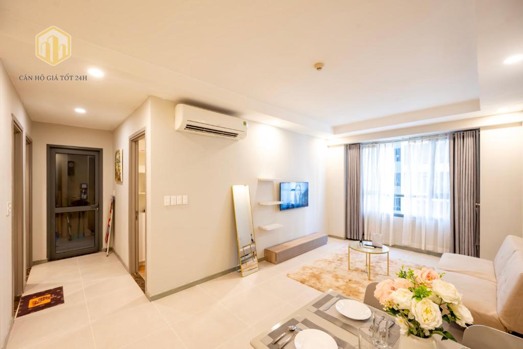 a living room with a couch and a table at The Gold View D4 - Canhogiatot24h in Ho Chi Minh City