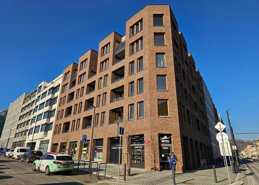Hotel Prague Smíchov Anděl Apartment, a tall brick building with a car parked in front of it at Prague Smíchov Anděl Apartment in Prague