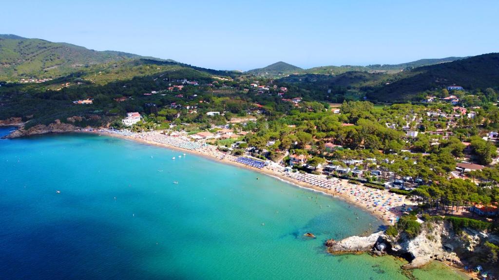 an aerial view of a beach with a town at Camping Bungalow Lido in Capoliveri