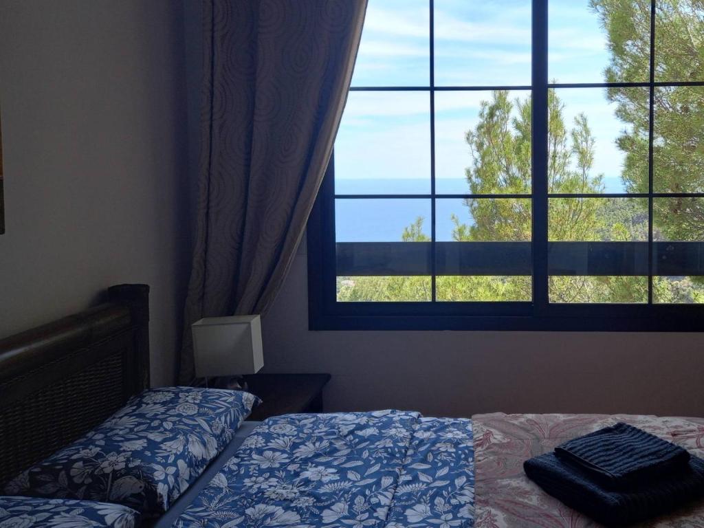 a bedroom with a bed and a large window at Townhouse Altea Hills in Altea