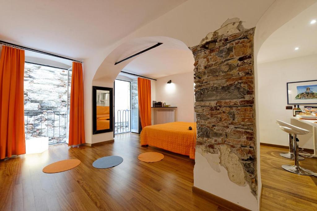 a bedroom with a bed and a stone wall at B&B dell'Acquario in Genova