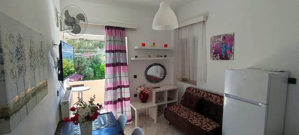 a small living room with a couch and a window at Chania City Apartments in Chania