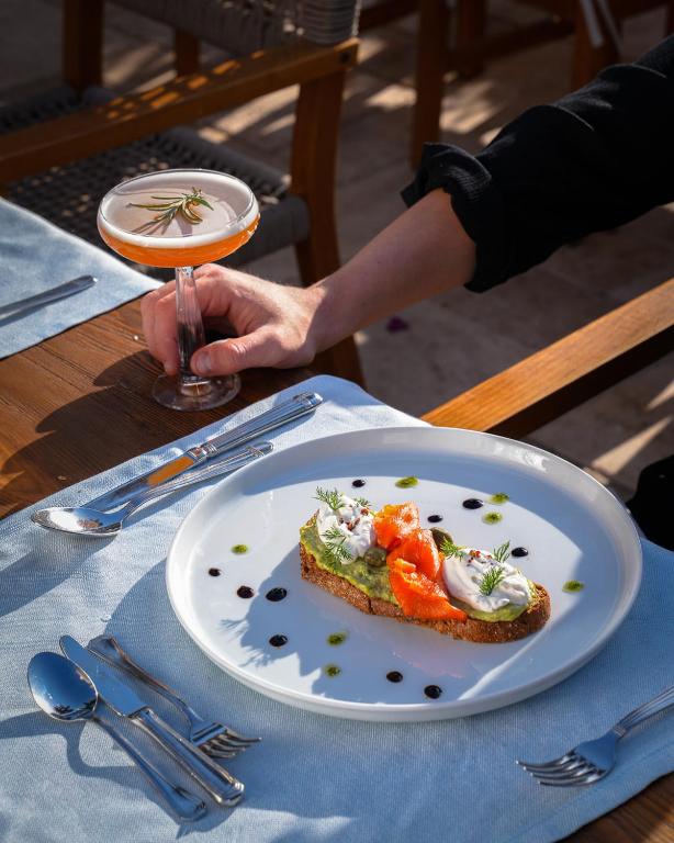 a person sitting at a table with a plate of food at Kassandra Boutique Hotel in Oludeniz