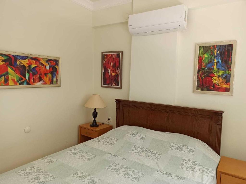 a bedroom with a bed and two paintings on the wall at NEXT TO CAFES, BEACH AND ALL AMENITIES in Antalya