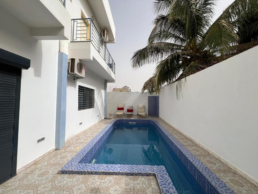 a swimming pool in the side of a house at Studio Villa Hortensia in Dakar