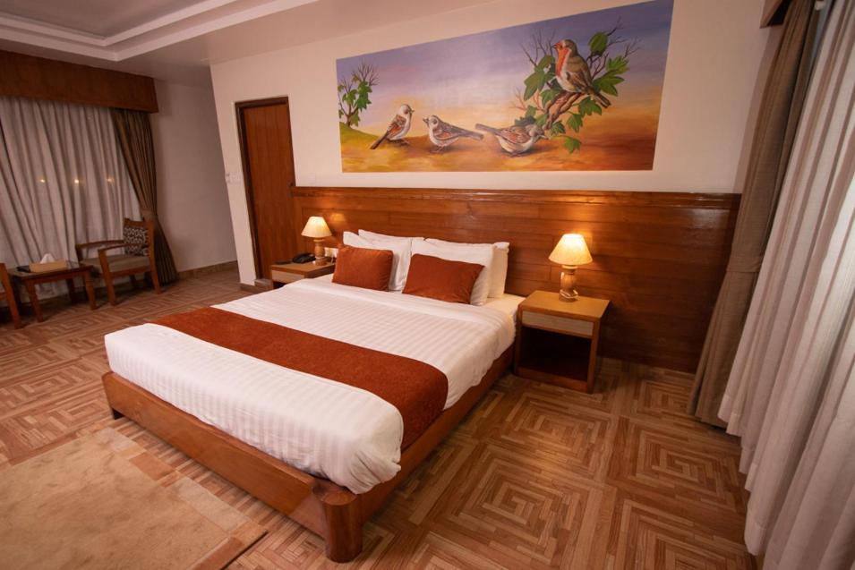 a bedroom with a large bed in a hotel room at Mount View Pokhara in Pokhara