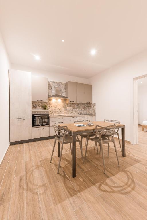 a kitchen with a table and chairs in a room at ORSOLA - New 2 BEDROOM Apartment in Valletta