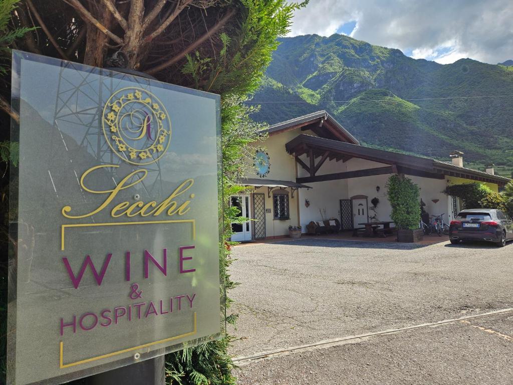 a sign in front of a winery with a building at Relais diVINO in Ala