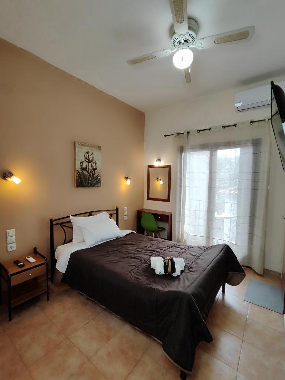 a bedroom with a bed with two towels on it at Poseidon Rooms in Kala Nera