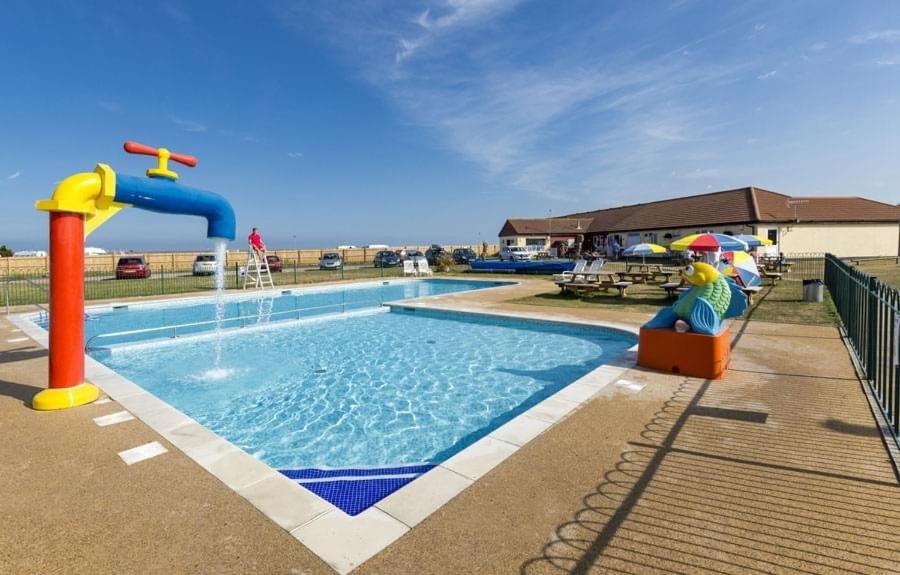 a pool with a water slide and a water park at Seaview Holiday Rentals - Seawall in Whitstable