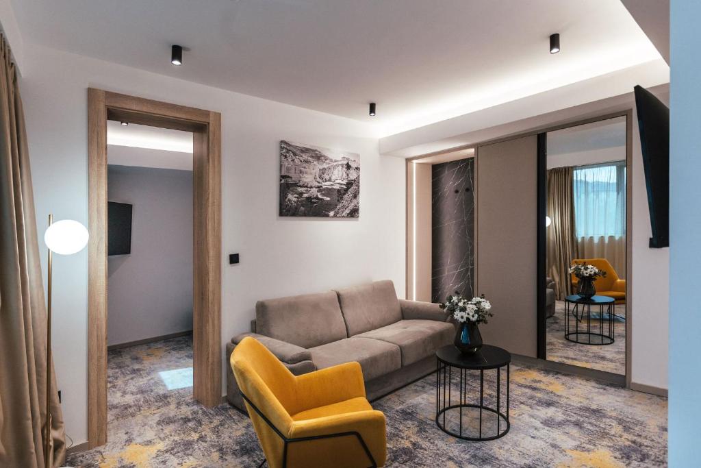 a living room with a couch and a chair at City Hotel Dubrovnik in Dubrovnik