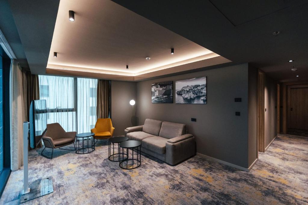 a living room with a couch and two chairs at City Hotel Dubrovnik in Dubrovnik