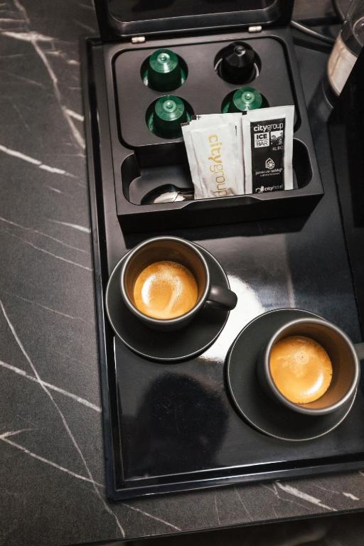 two cups of coffee sitting on a tray at City Hotel Dubrovnik in Dubrovnik
