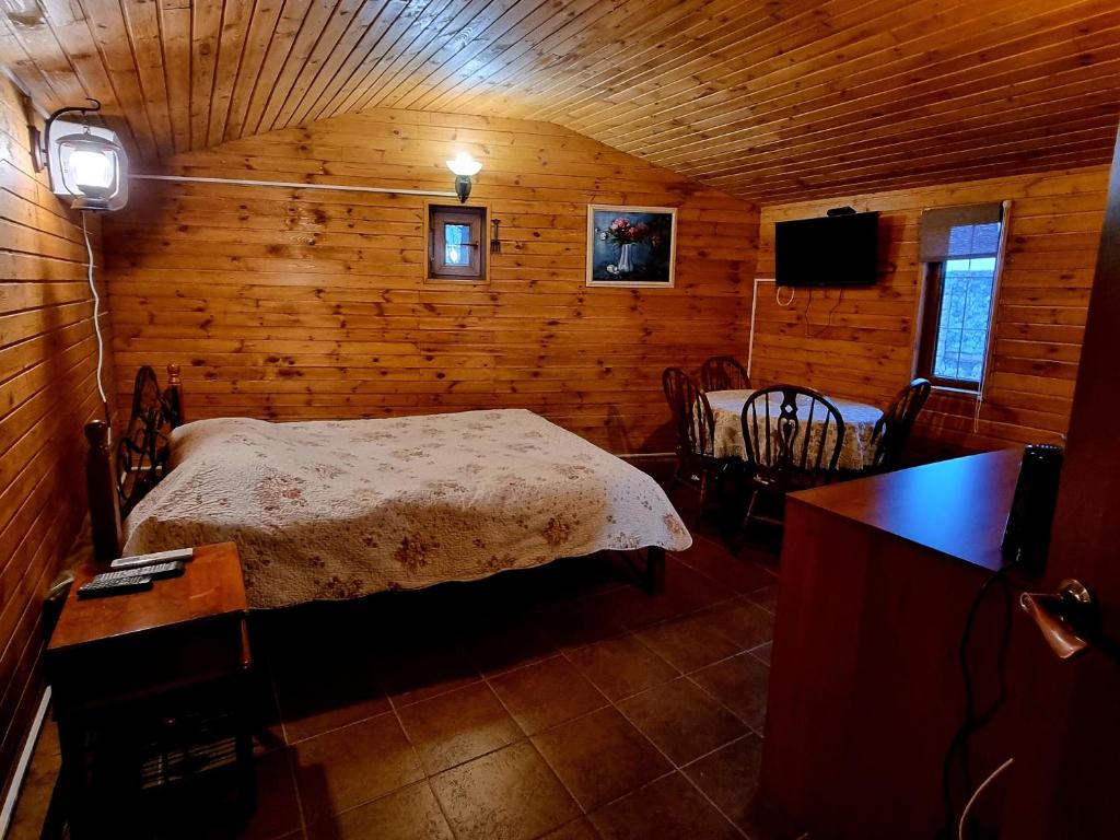 a bedroom with a bed in a wooden room at Krolichya ferma in Ivancea