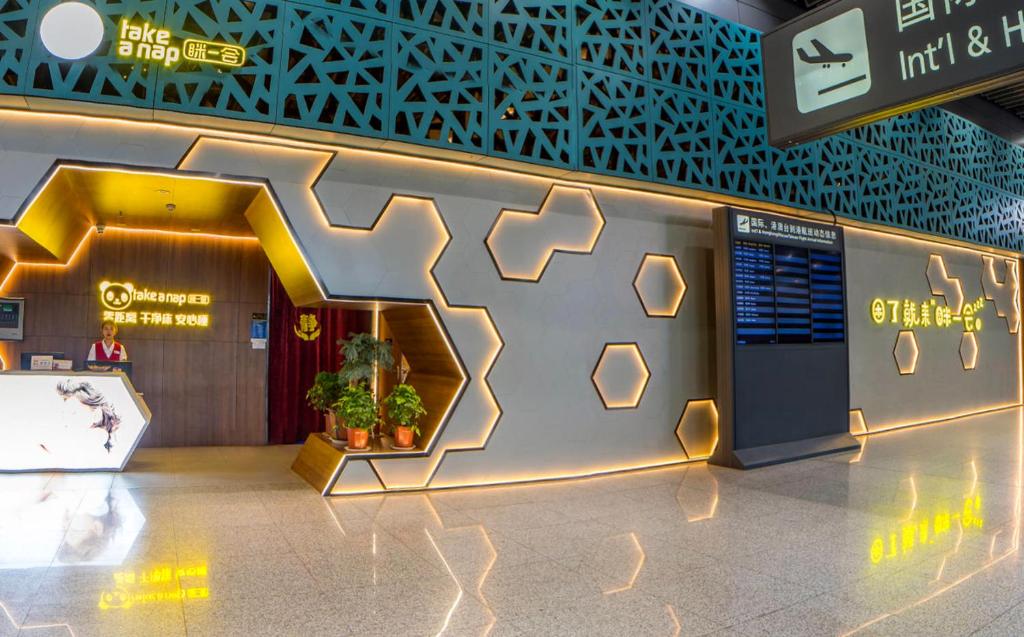 a lobby of a building with a sign on the wall at Xi'an Xianyang International Airport Space Capsule Hotel in Xi'an