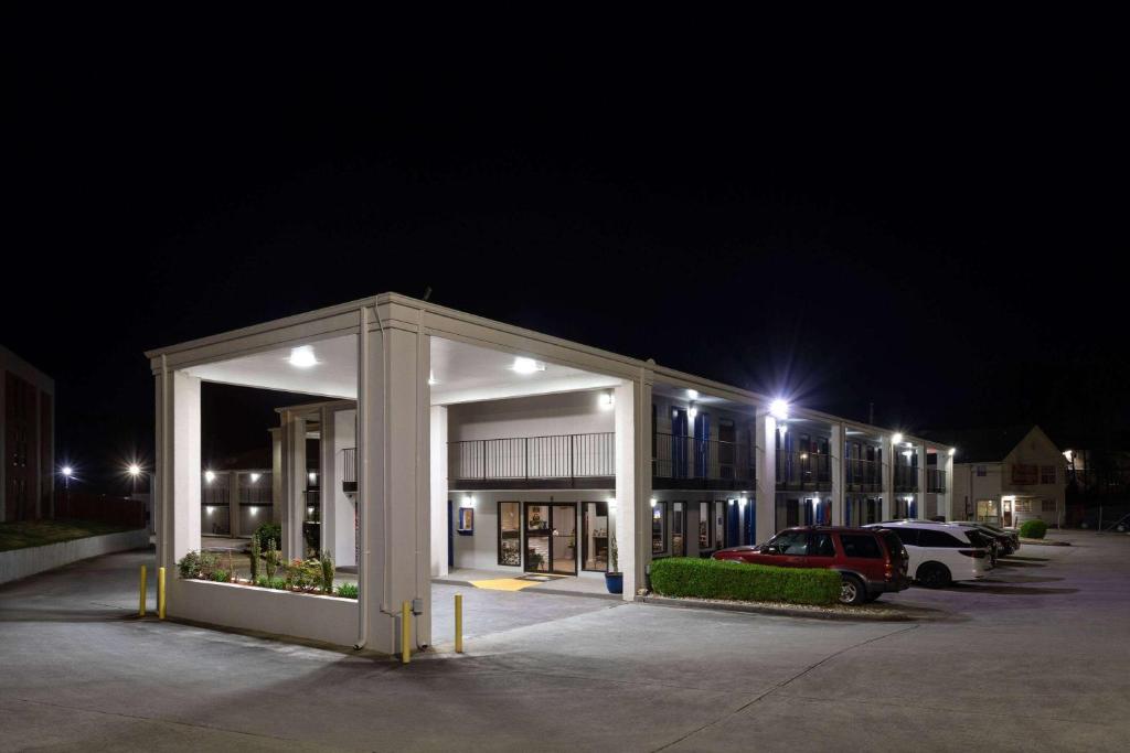 a building with a car parked in a parking lot at night at Days Inn by Wyndham Douglasville-Atlanta-Fairburn Road in Douglasville