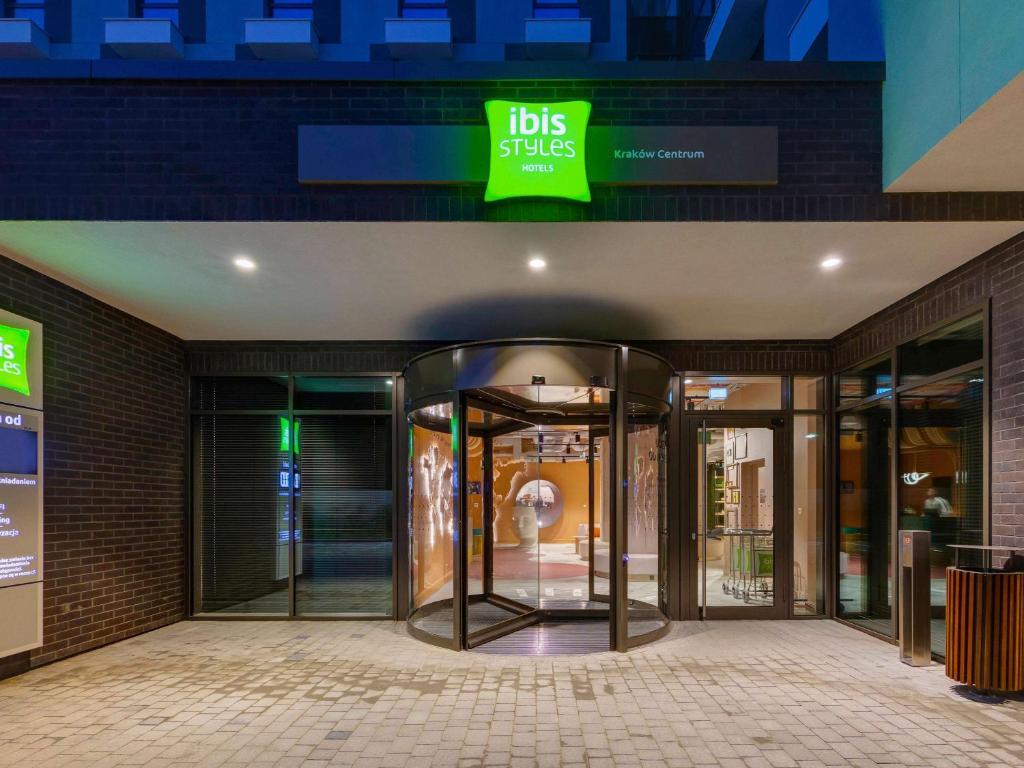a store front with revolving doors in a building at ibis Styles Kraków Centrum in Krakow