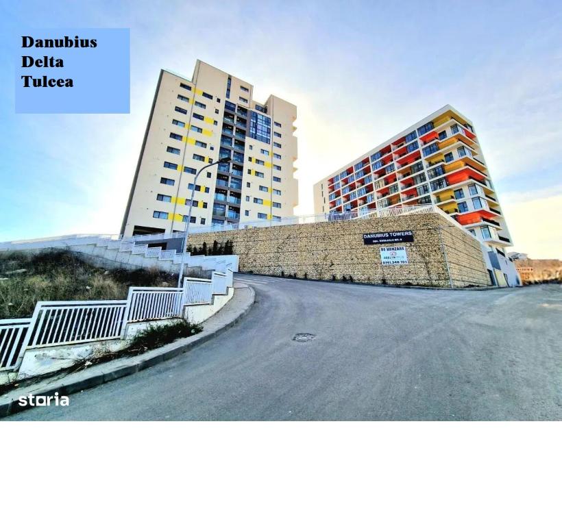 an empty road in front of two tall buildings at Danubius Delta Tulcea in Tulcea