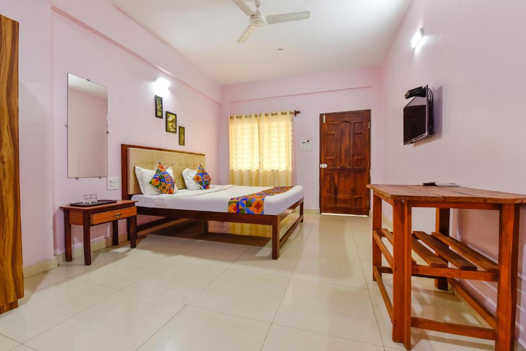 a bedroom with a bed and a television in a room at FabExpress Morjim Paradise in Morjim