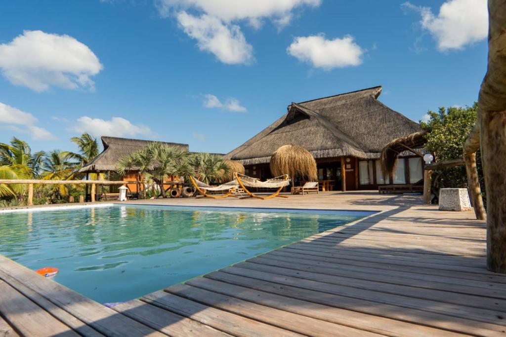 a villa with a pool and a resort at Sia Sente Beach estate in Inhambane