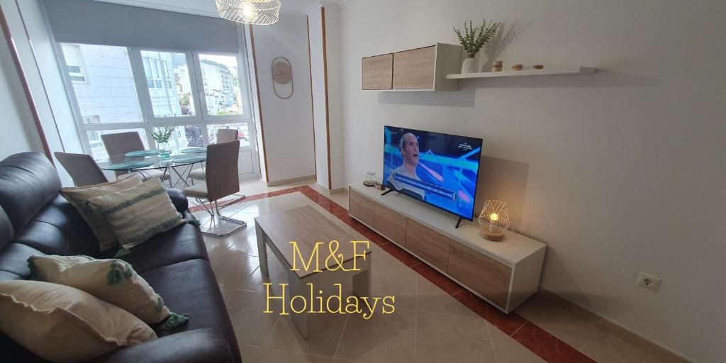 a living room with a couch and a flat screen tv at Mirasol in Viveiro