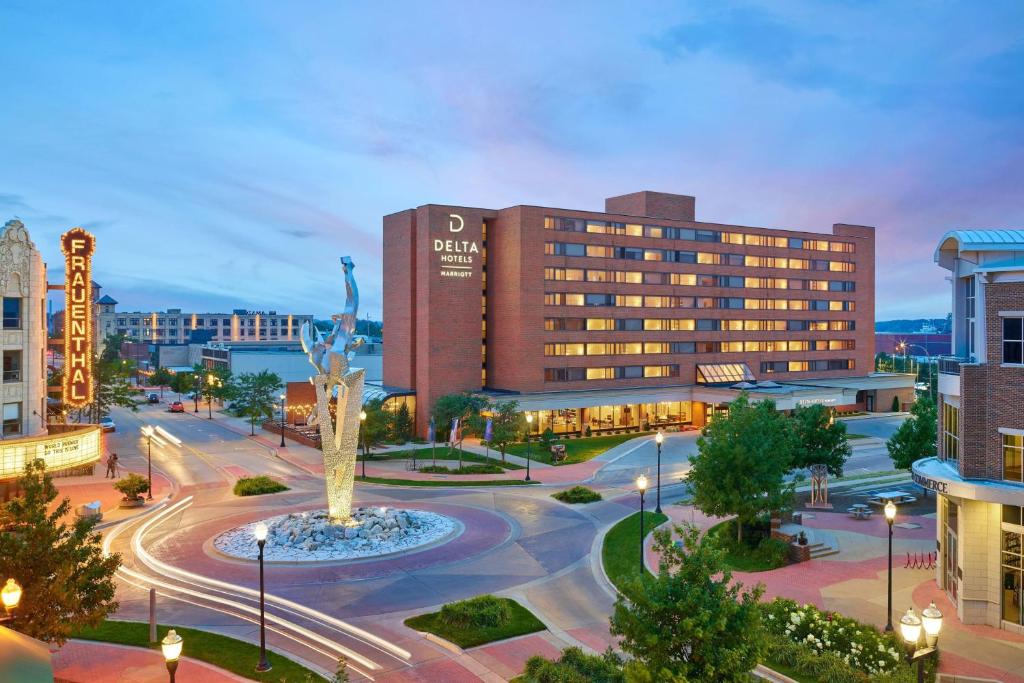 a building with a statue in the middle of a city at Delta Hotels by Marriott Muskegon Convention Center in Muskegon