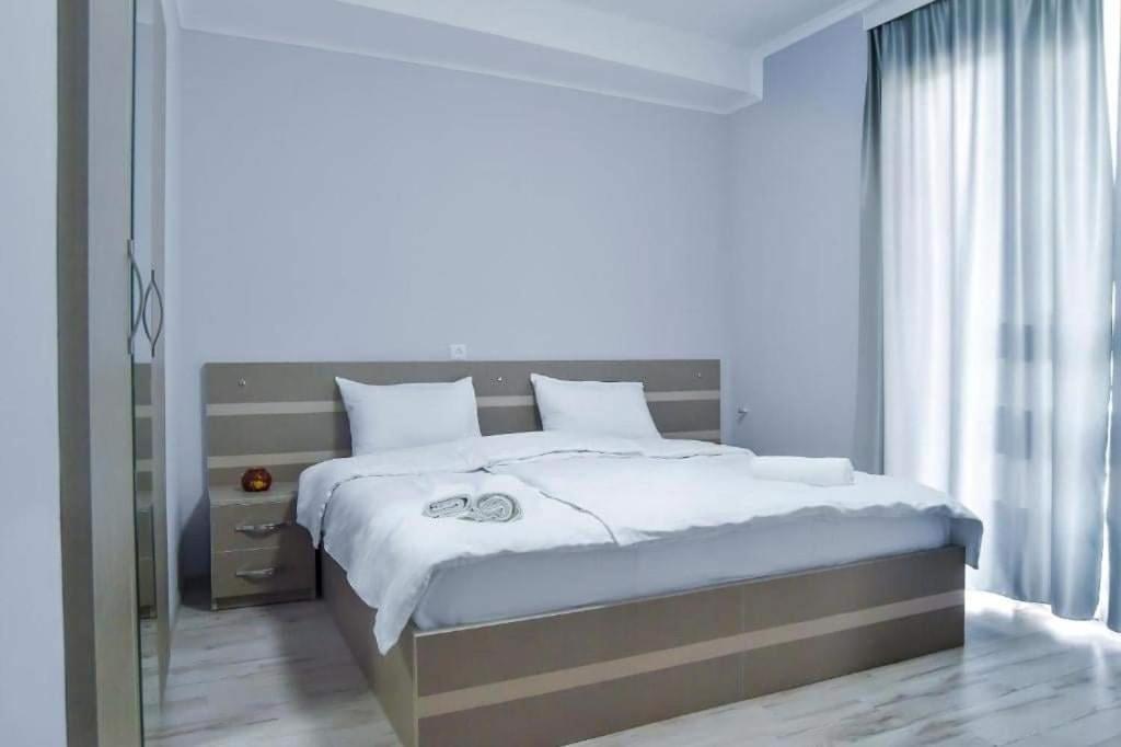 Un dormitorio con una cama grande y una ventana en City Hotel Kutaisi en Kutaisi