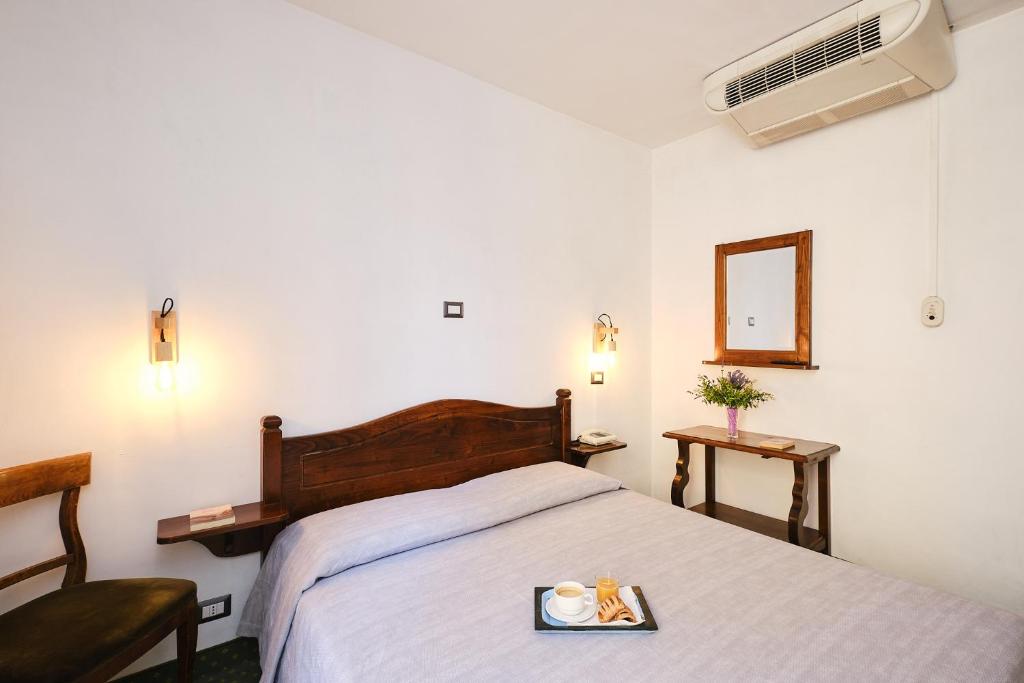 Postel nebo postele na pokoji v ubytování Albergo Della Posta