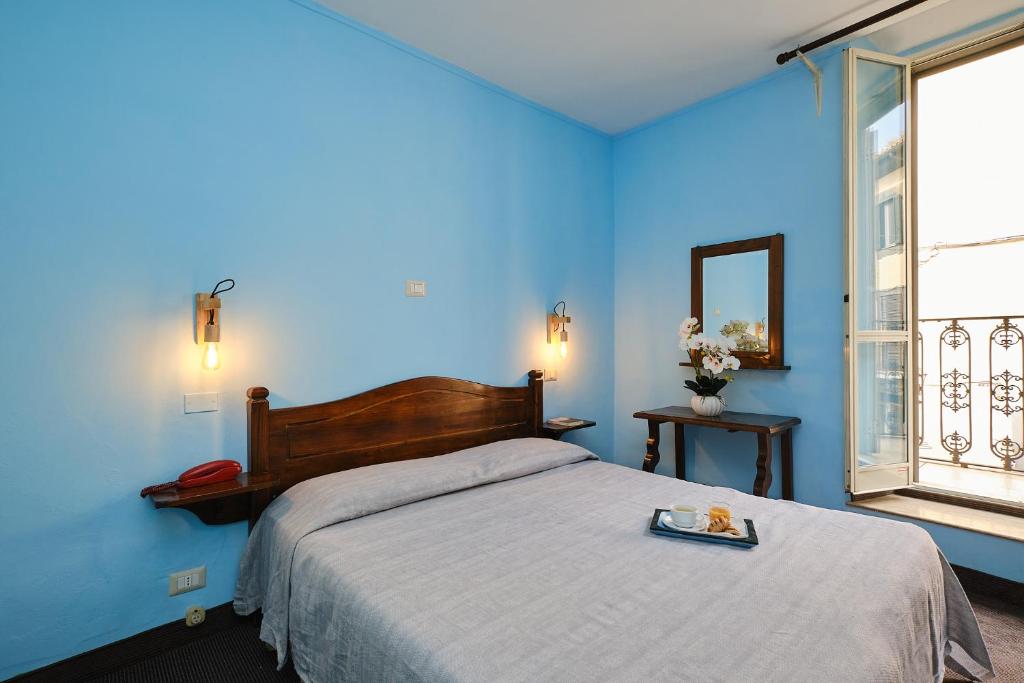 Postel nebo postele na pokoji v ubytování Albergo Della Posta
