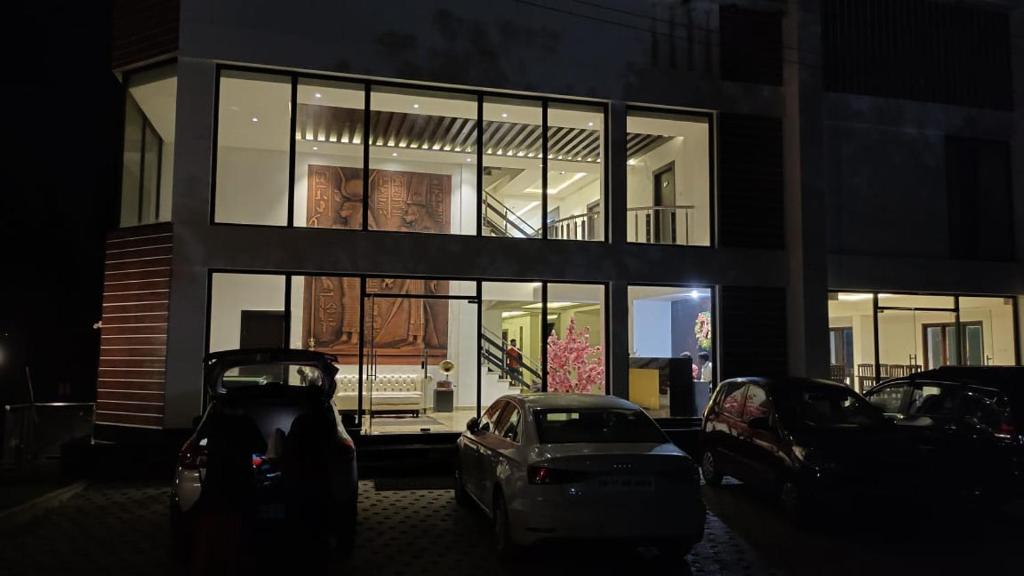 a car parked in front of a building with large windows at Infinity Destination's Kodaikanal - 0014 in Kodaikānāl