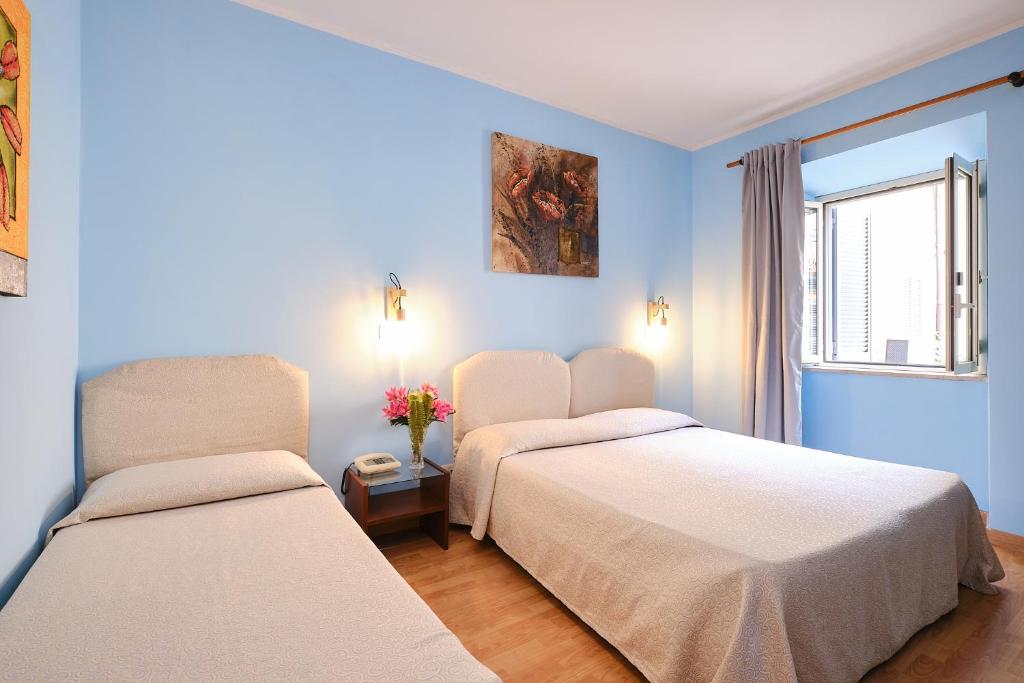Postel nebo postele na pokoji v ubytování Albergo Della Posta