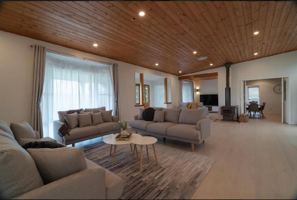 a large living room with couches and a table at Yasar farm stay Marshall view 