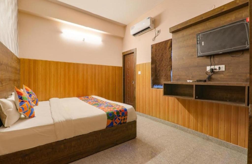 1 dormitorio con 1 cama y TV de pantalla plana en Gsv hotel en Kānpur