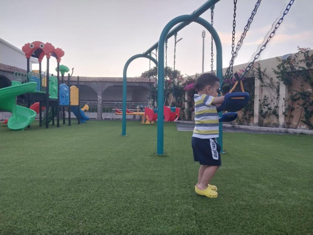 un niño está jugando en un patio de recreo en Complex Amazon Guercif en Guercif