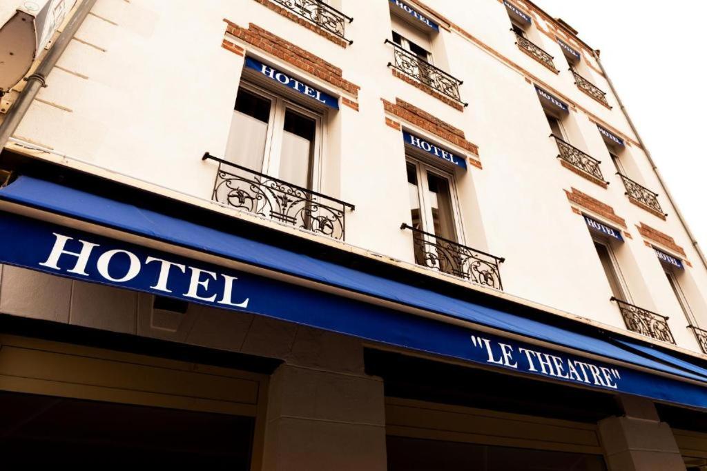 a hotel sign on the side of a building at Le Val D'or & Le Theatre in Suresnes