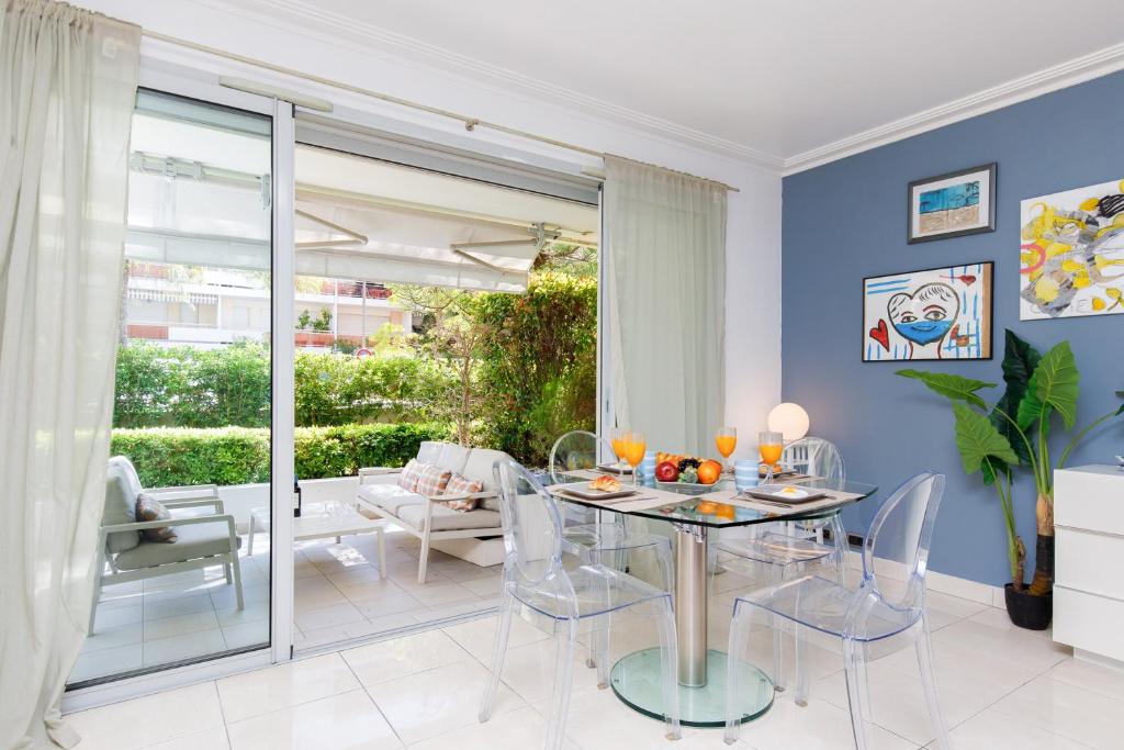 une salle à manger avec des murs bleus et une table et des chaises dans l'établissement Cristal Croisette YourHostHelper, à Cannes
