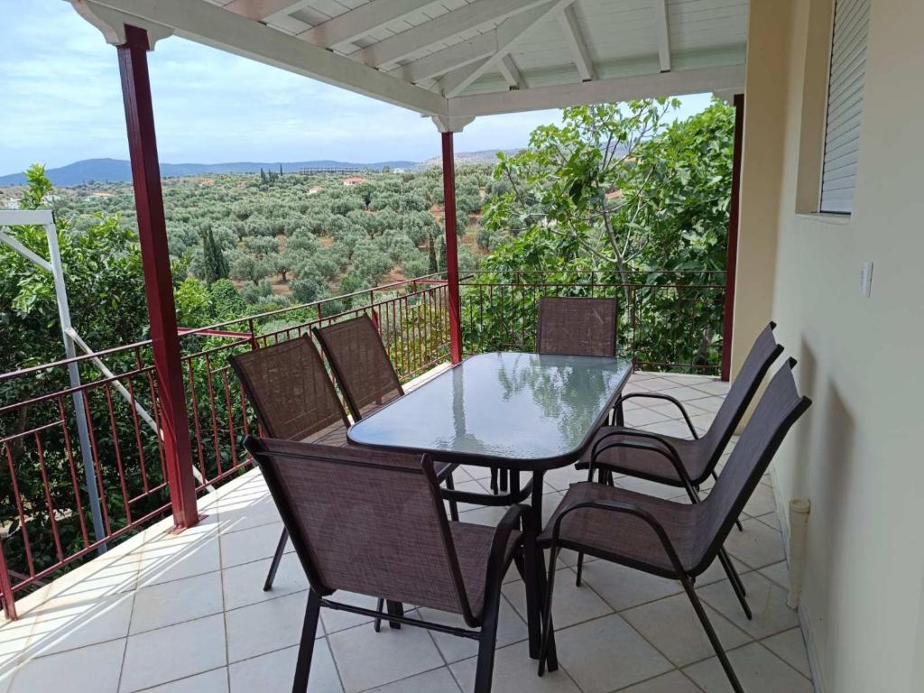 a patio with a table and chairs on a balcony at Konstantina's House I in Koroni