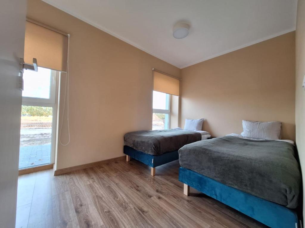 Ένα ή περισσότερα κρεβάτια σε δωμάτιο στο Apartament 3A Świętoszewo 12