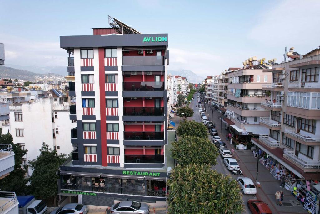 un edificio de apartamentos en una ciudad con coches aparcados en Avlion Boutique Hotel, en Alanya