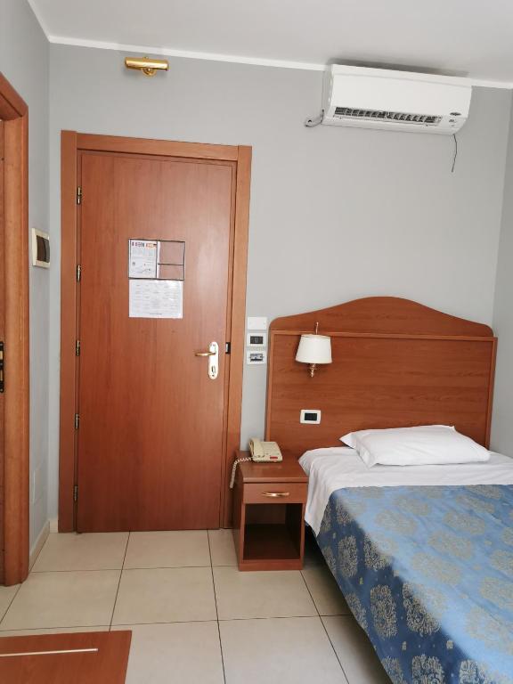 Postel nebo postele na pokoji v ubytování Hotel Rigolfo