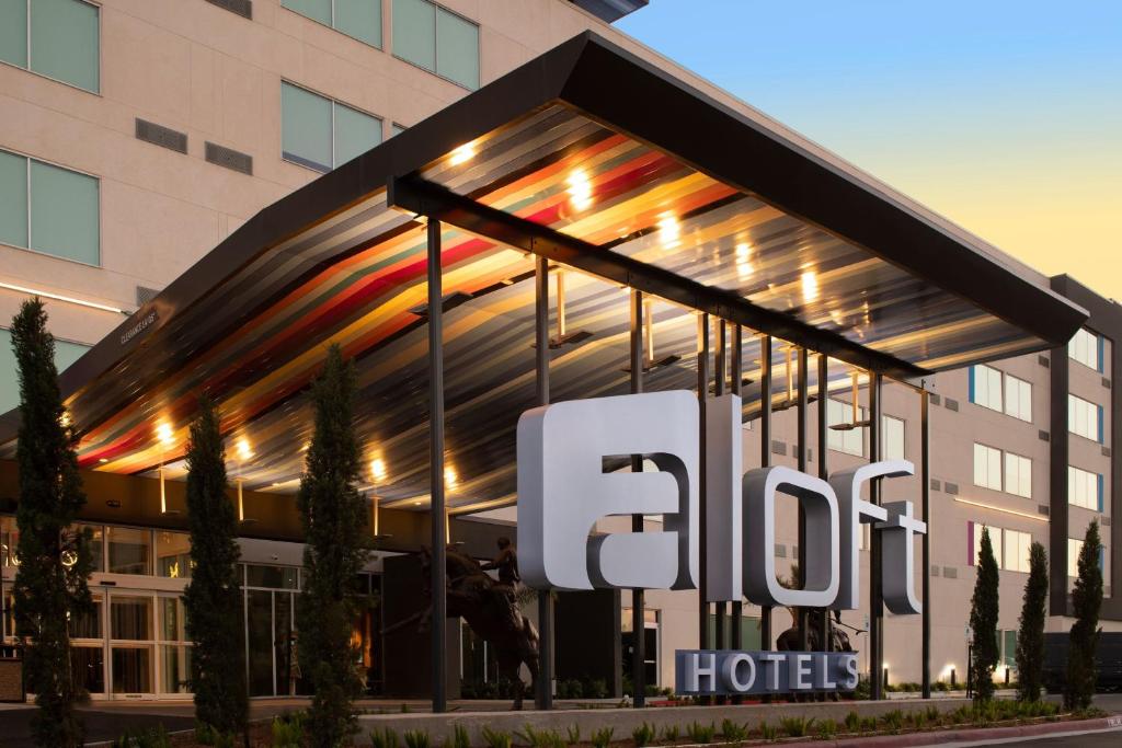 a hotel sign in front of a building at Aloft McAllen in McAllen