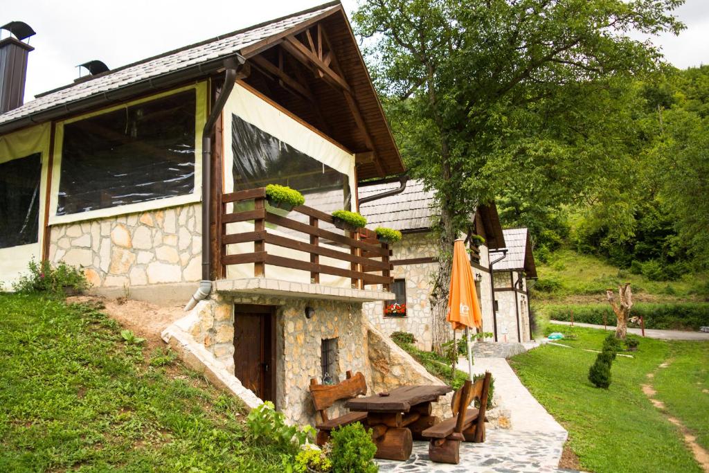 a building with a picnic table in front of it at Vikendice - Vodenica Jurić in Prozor