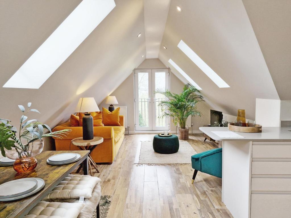 an attic living room with a skylight at Roseland Penthouse - Arundel in Arundel