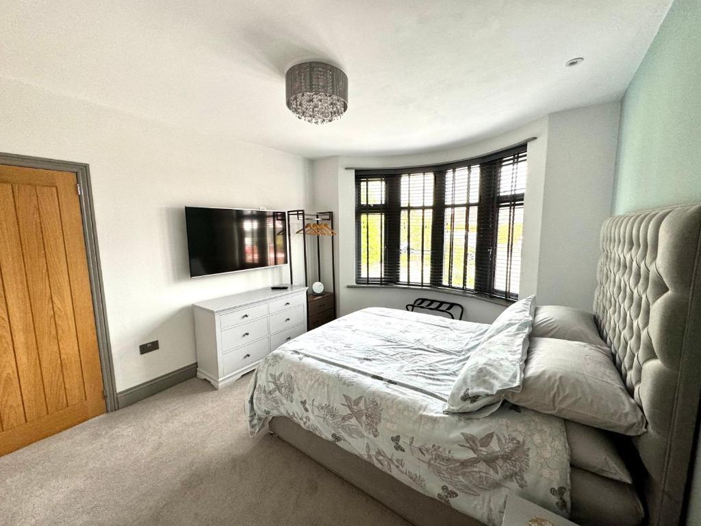 a bedroom with a bed and a television in it at No.3 in Cardiff