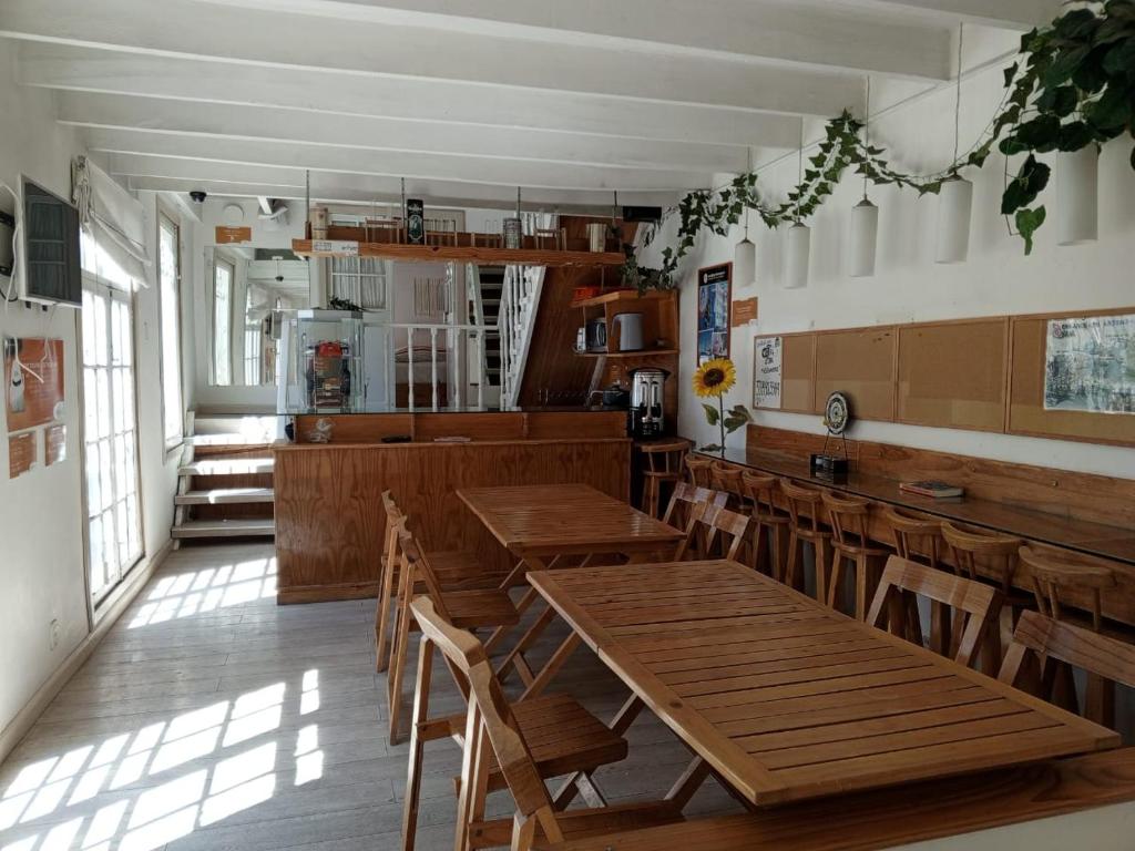 a dining room with wooden tables and chairs at Atatau hostel in La Paz